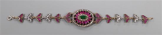 An Indian? yellow and white metal, ruby emerald and white sapphire set bracelet, 19cm.